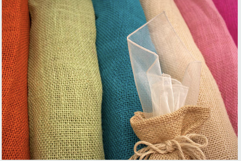 A collection of eco-friendly colored jute fabrics showcasing diverse shades and natural woven textures.